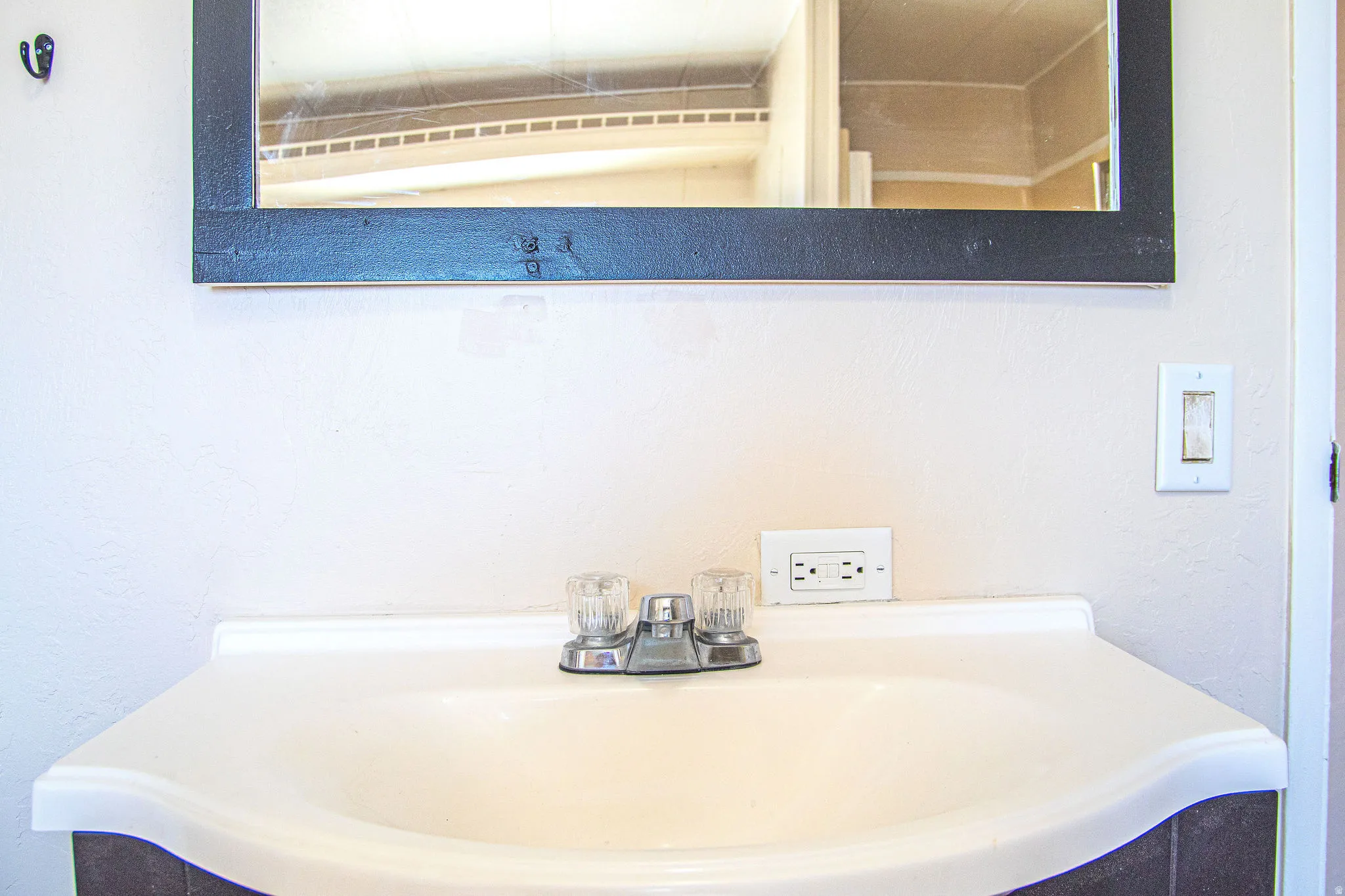 Integrated vanity sink with a two-handle faucet and a framed mirror