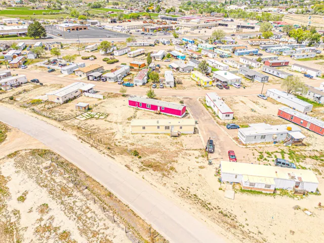 Expansive parcel featuring multiple manufactured homes, established roadways, and a surrounding arid landscape