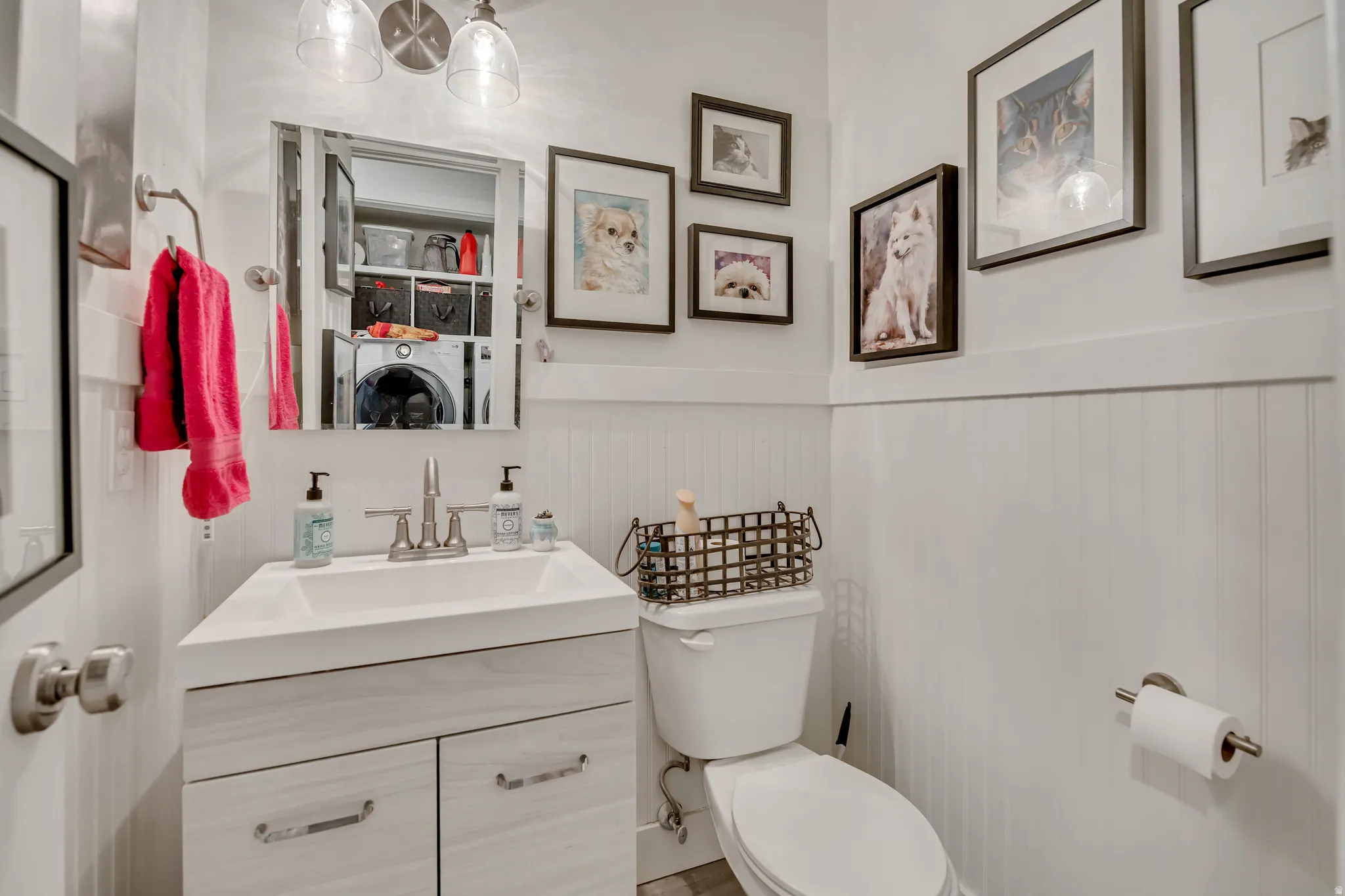 Bathroom featuring a vanity with a rectangular sink, dual-door cabinet, brushed nickel faucet, and a wall-mounted mirror