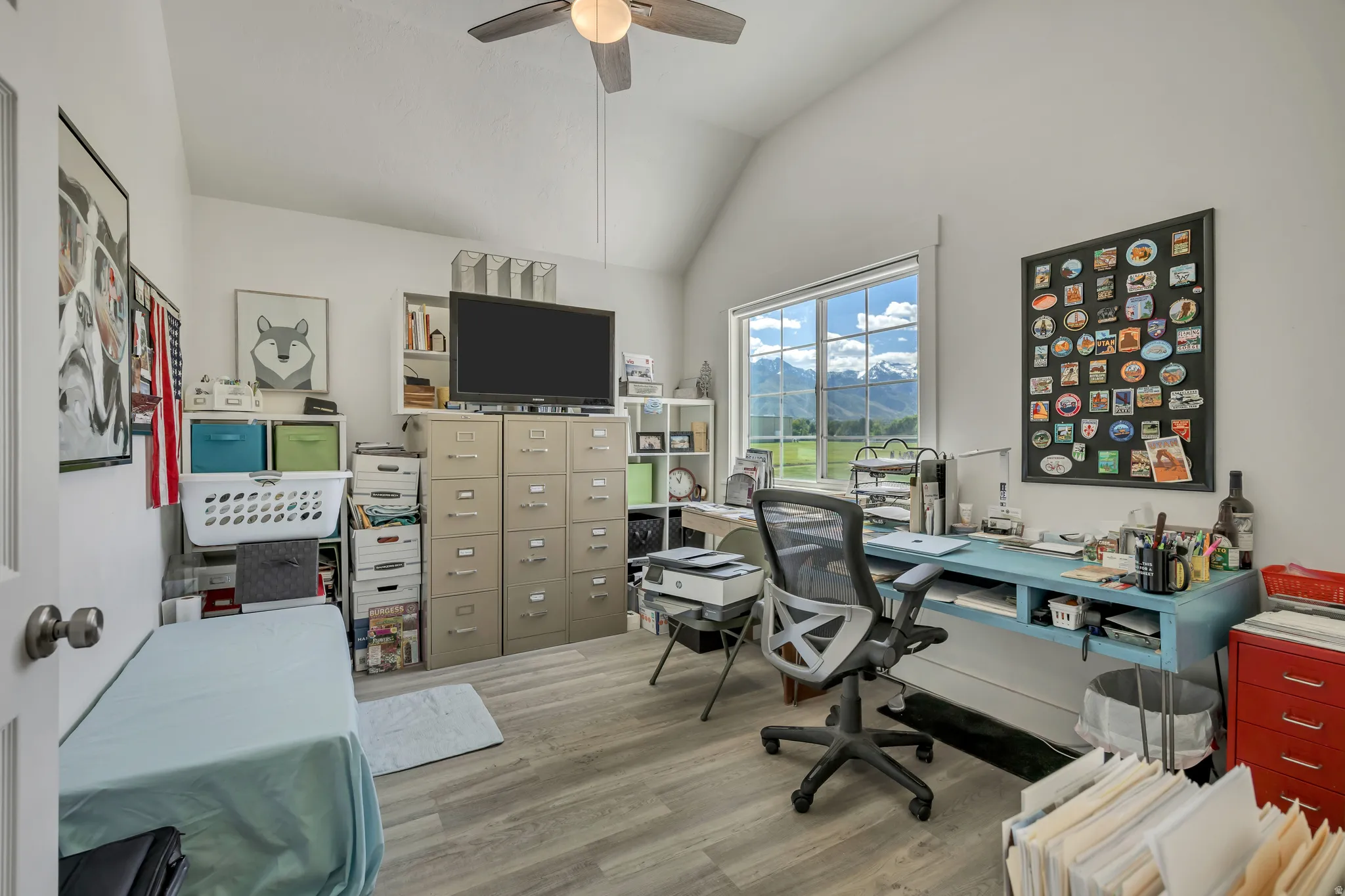 Bright room with vaulted ceiling and wood-finish flooring