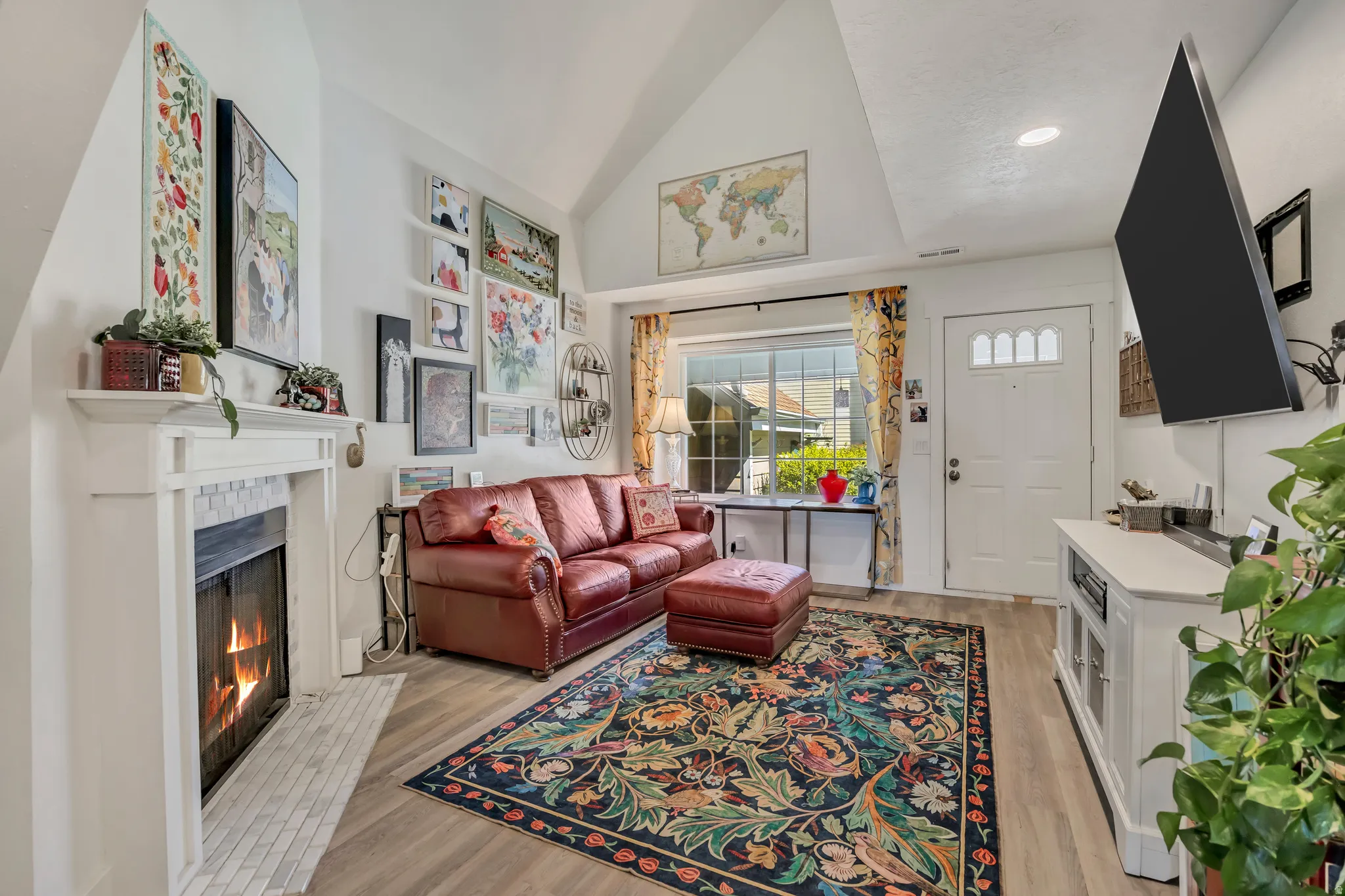 Living area featuring a fireplace with a white mantel and mosaic tile surround