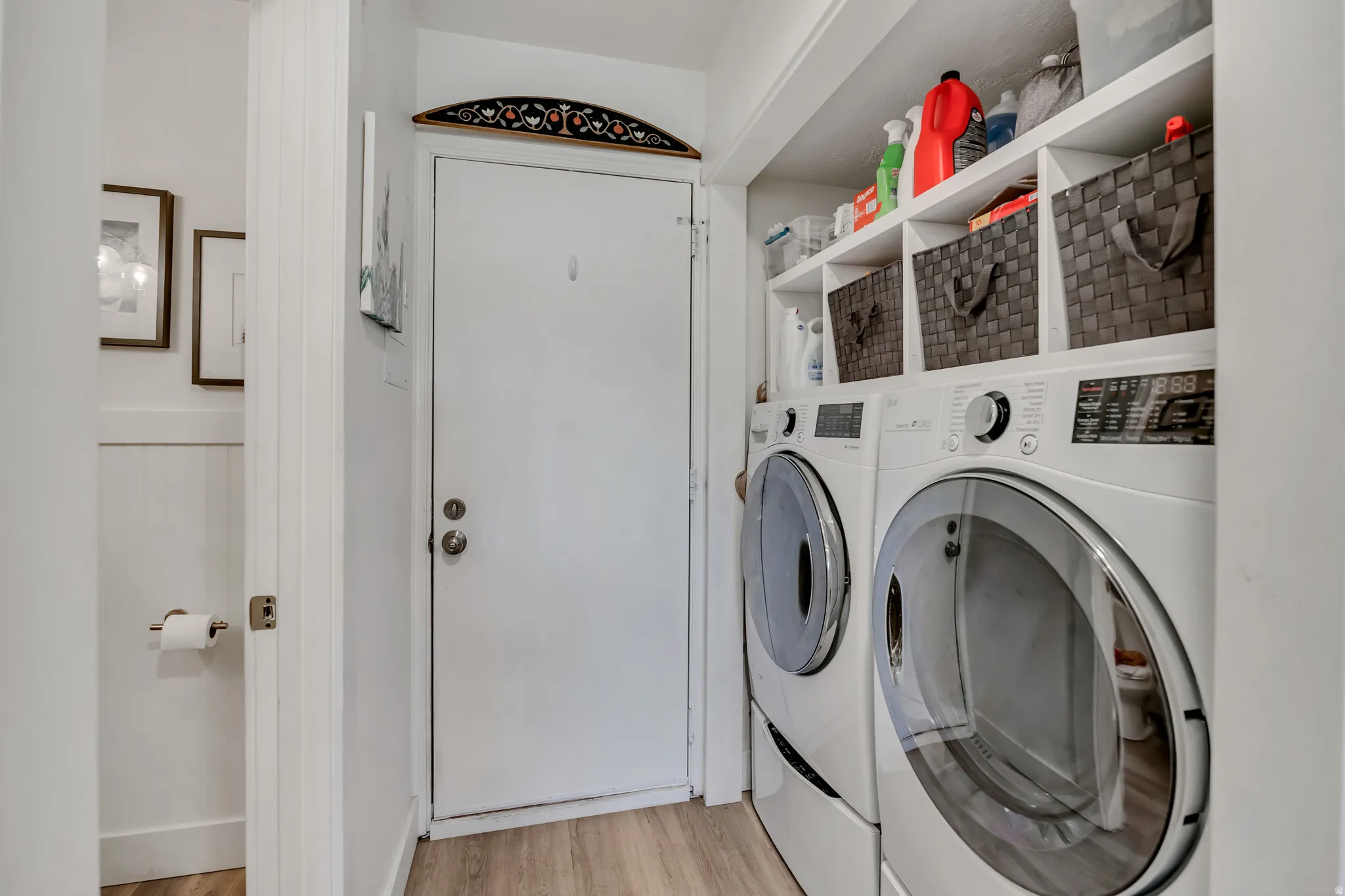 Dedicated laundry area featuring front-loading washer and dryer units