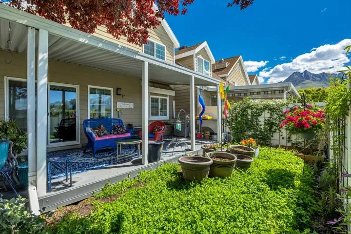 Expansive covered patio featuring a full roof, multiple support columns, and direct access to interior spaces through sliding glass doors