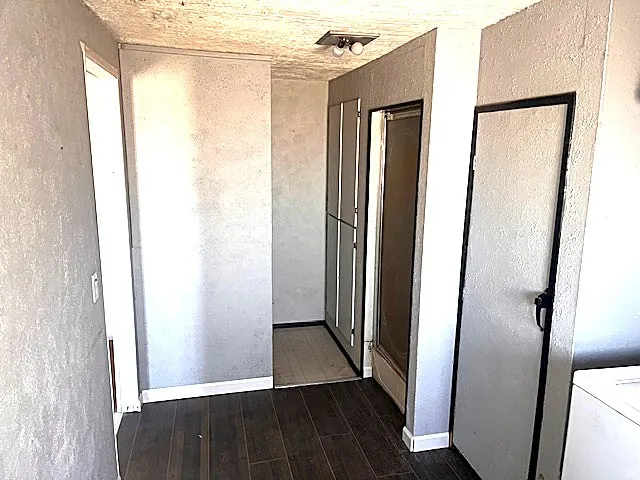Wood-finish flooring throughout, complemented by light-toned wall finishes and white baseboards