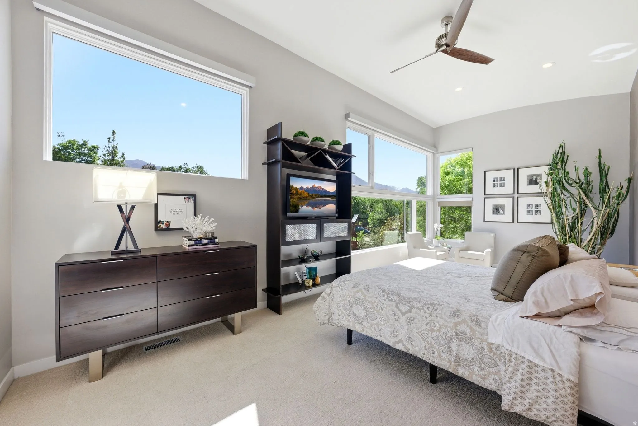High ceilings with recessed lighting, large picture windows, and a multi-pane window wall
