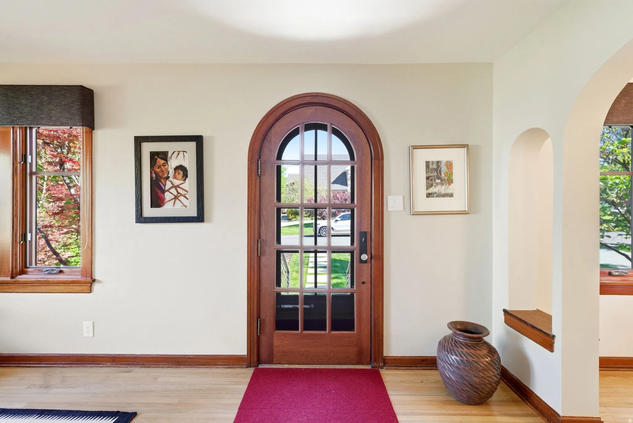 Arched wood-frame entry door with multi-pane glass