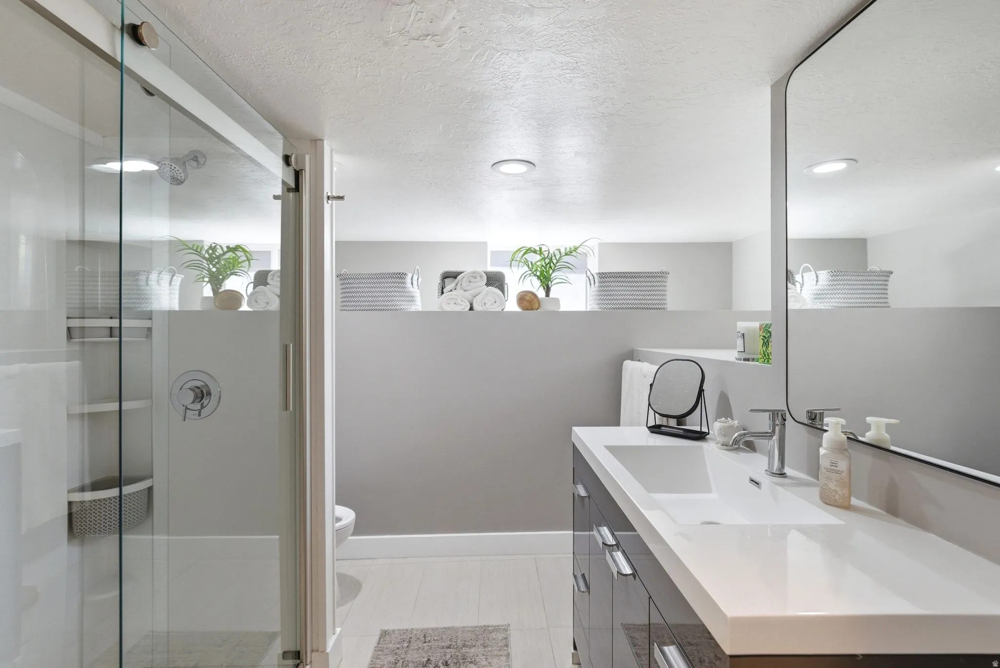 Modern bathroom featuring a glass-enclosed shower with chrome fixtures