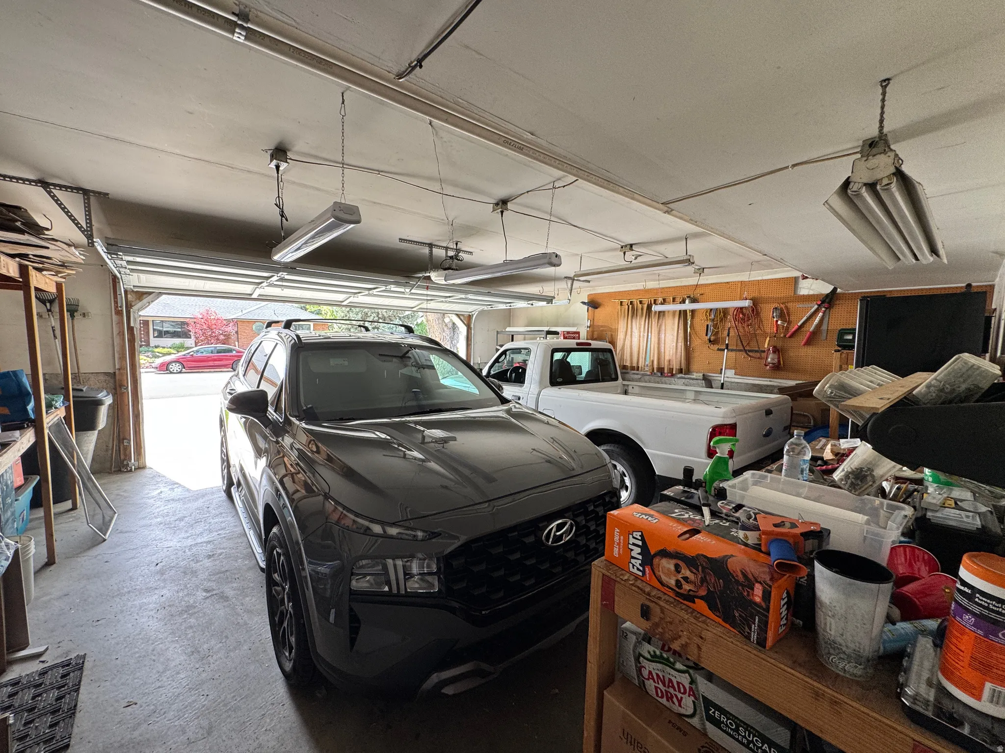 Spacious two-car garage with overhead lighting and a workbench