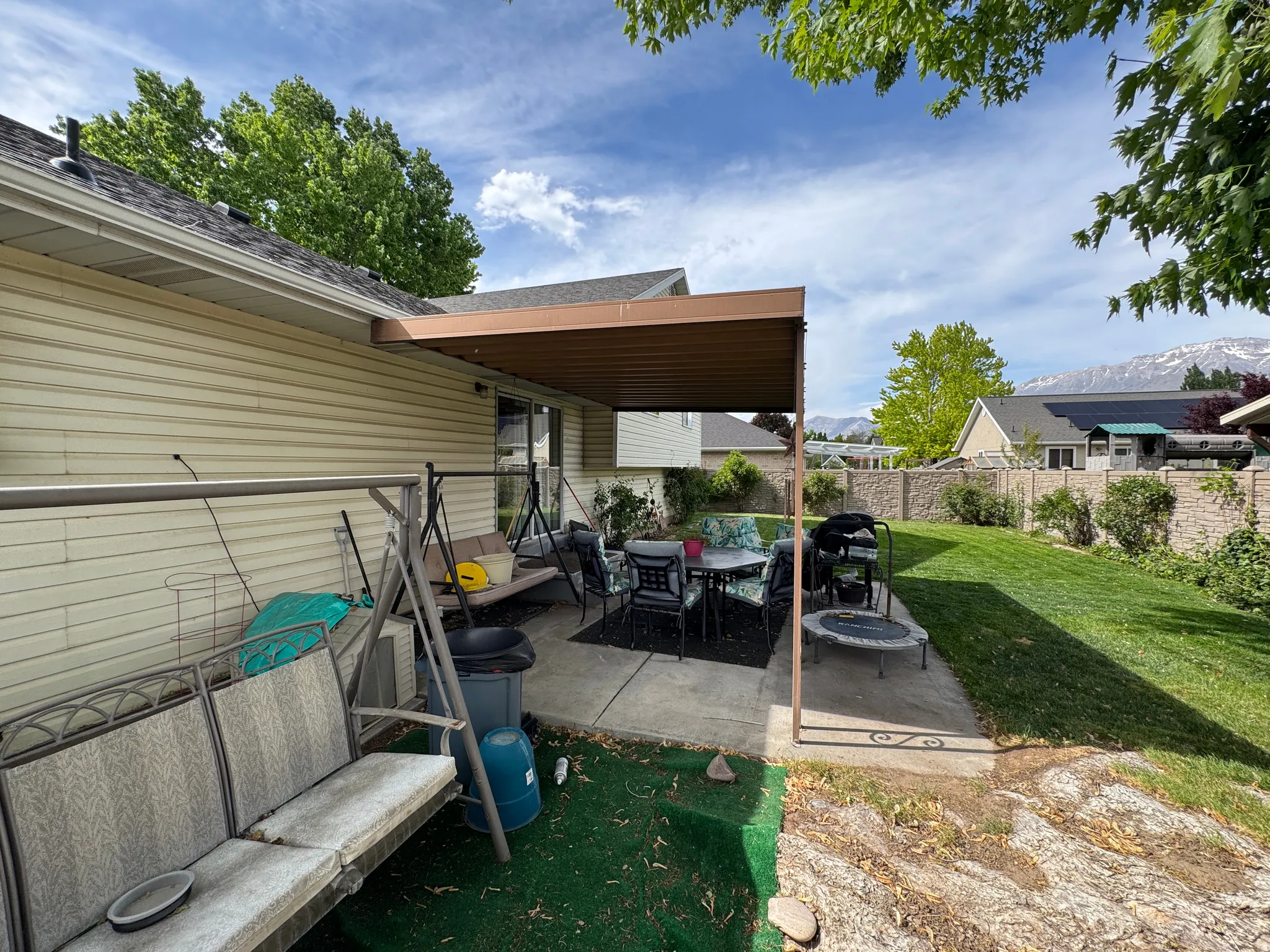 Rear patio with an attached awning providing covered outdoor space