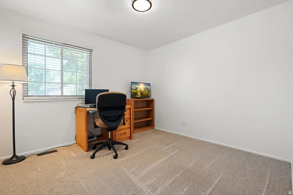 Carpeted room with a window featuring horizontal blinds, recessed lighting, and white walls