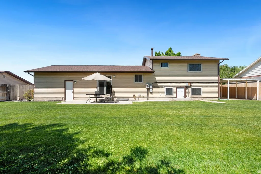 Expansive green lawn with a concrete patio