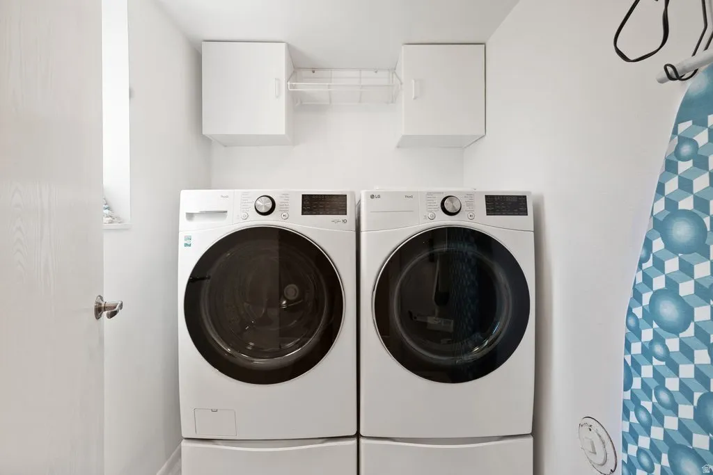White front-loading washer and dryer set with pedestal bases