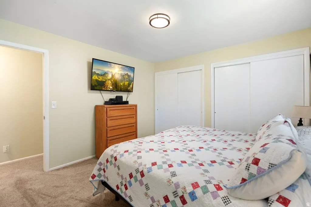 Carpeted bedroom featuring neutral-toned walls and a recessed doorway