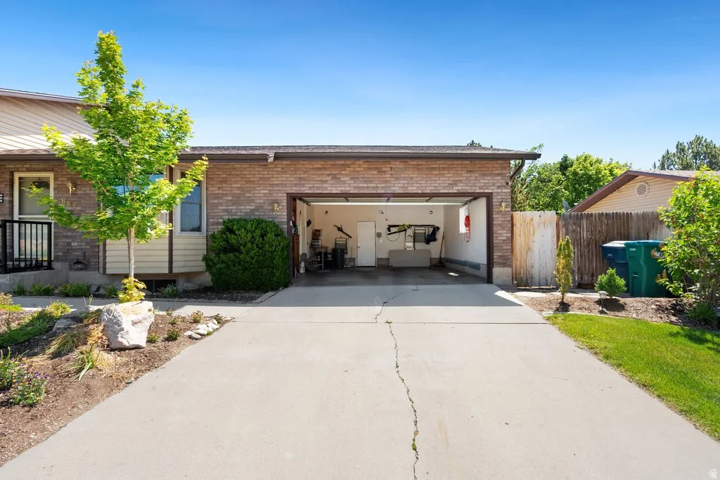 Extra long two-car garage with a concrete driveway
