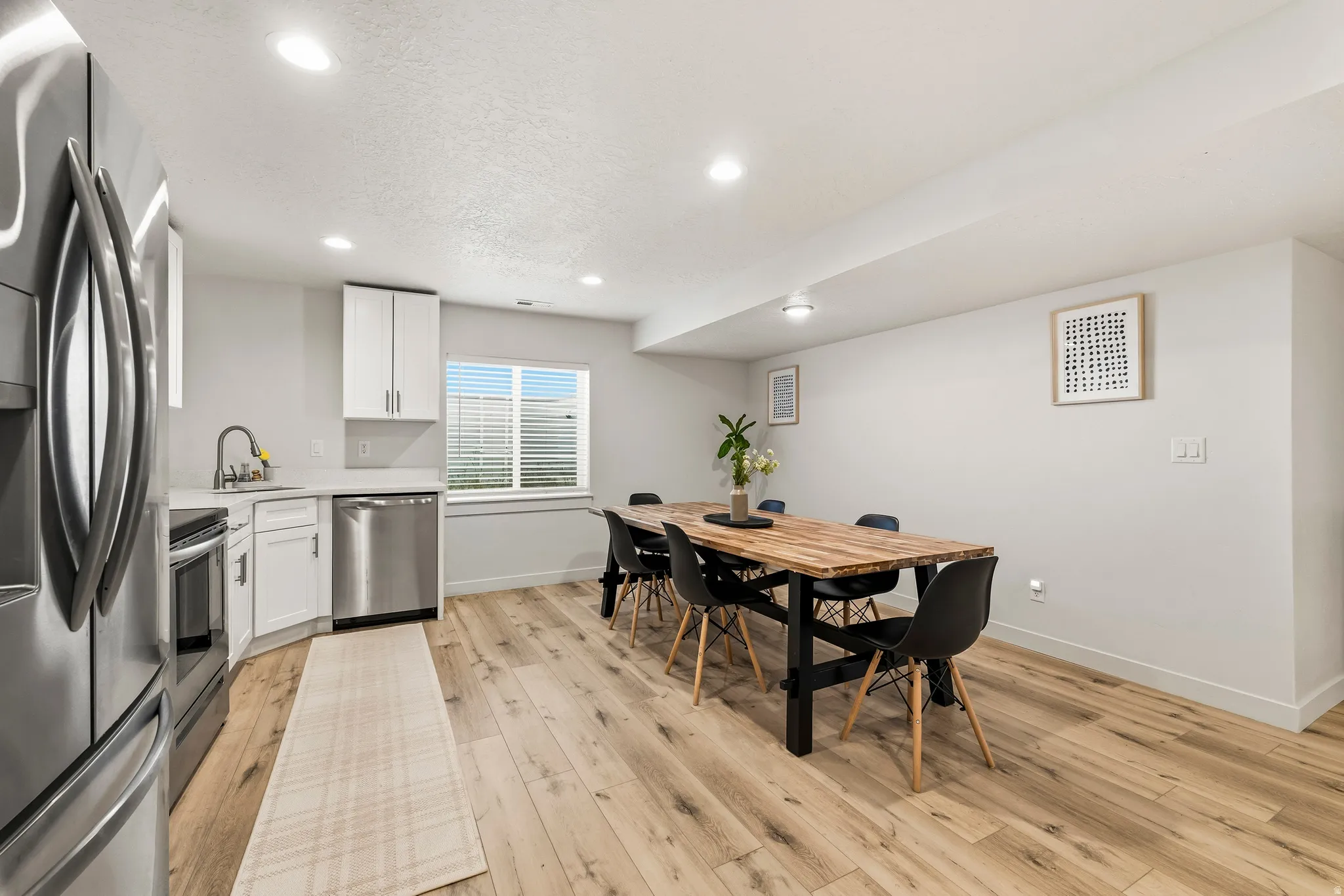 Open-concept living space with light wood-finish flooring