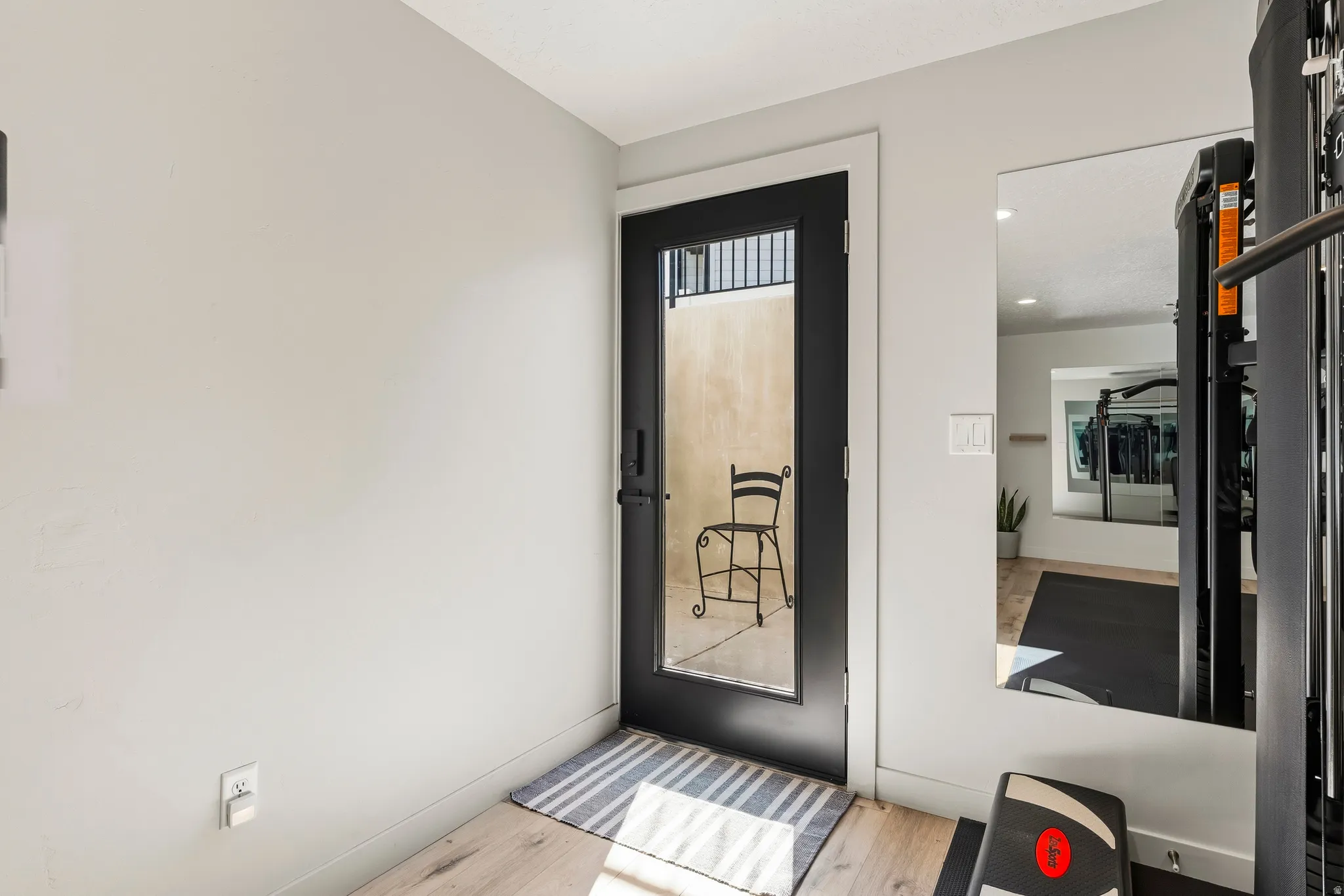 Full-light glass door with black frame and hardware