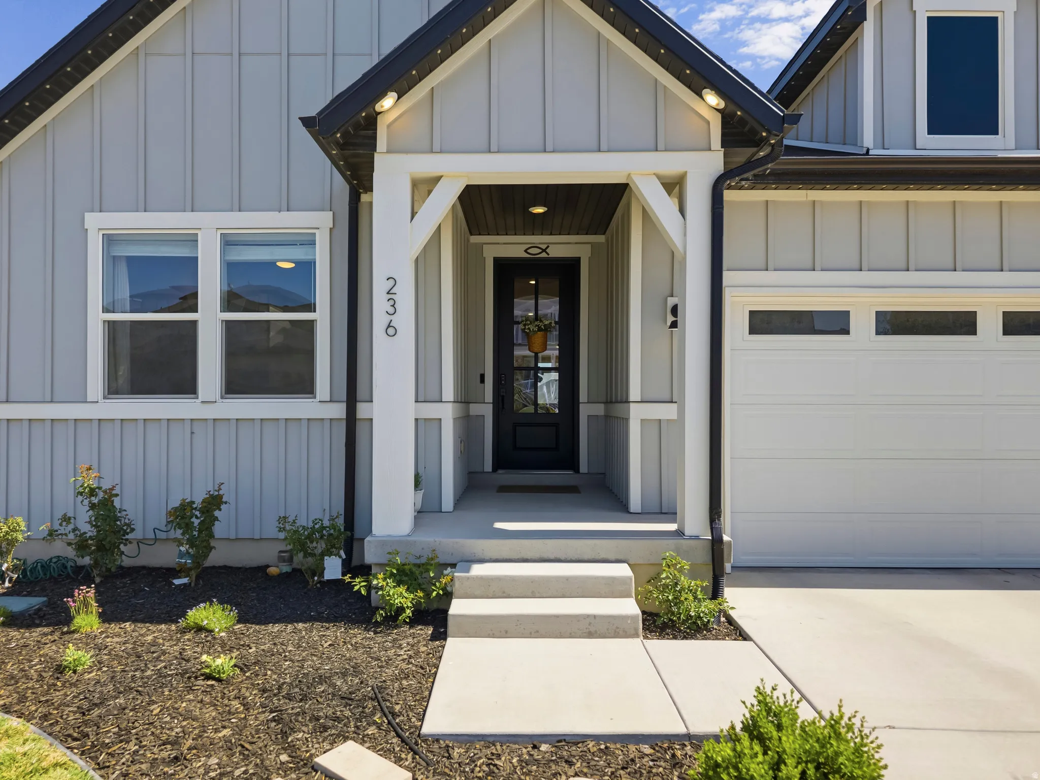 Light gray board and batten siding with white trim