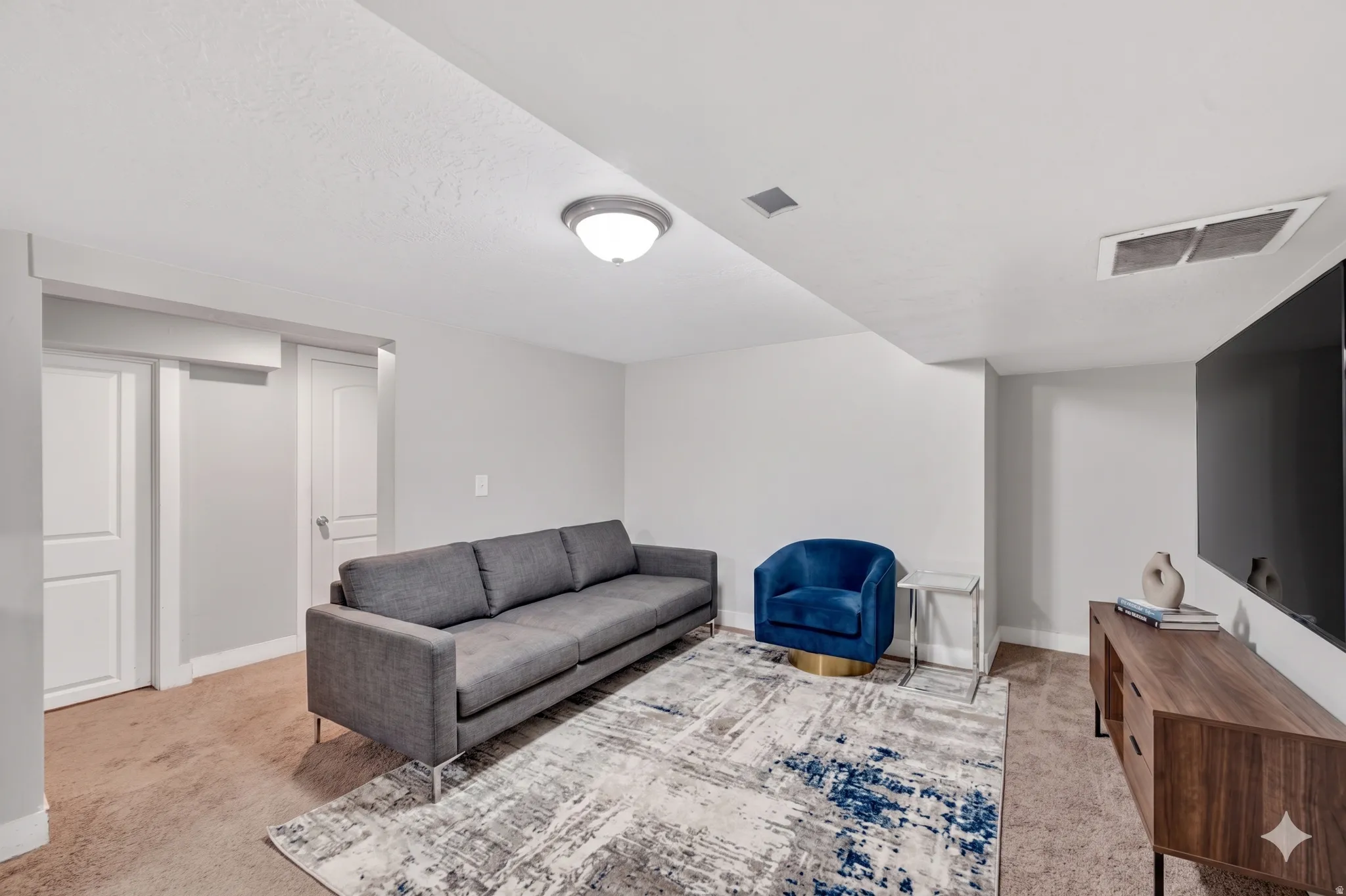 Finished interior space featuring light-colored walls and ceiling, recessed lighting, and carpeted flooring