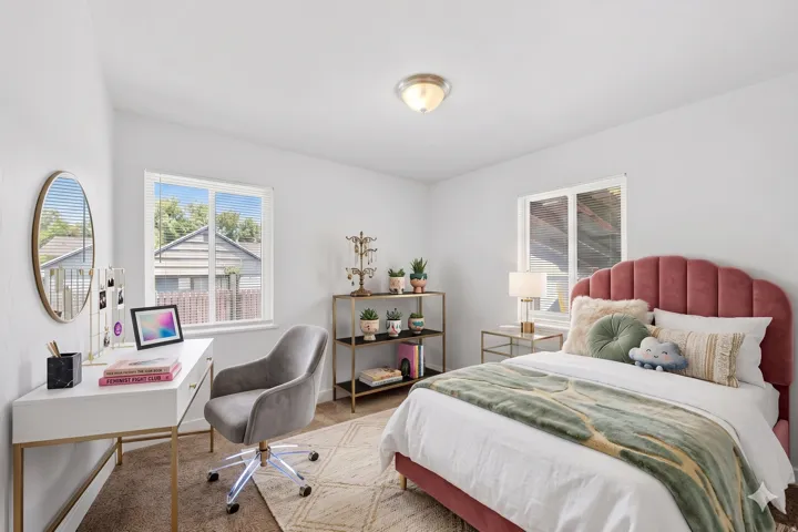 Bright interior space featuring a window, light-colored walls, and a ceiling-mounted light fixture