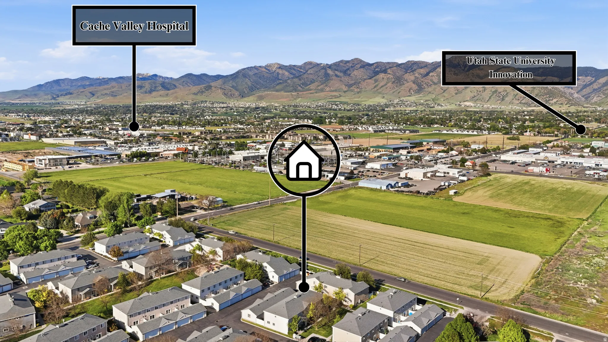 Aerial perspective of a developed community with mountain backdrops