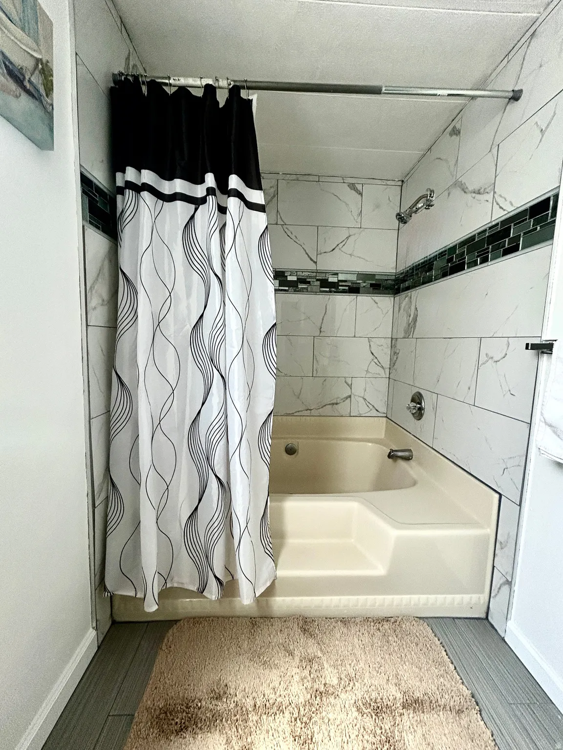 Master bathroom featuring a shower-tub combination