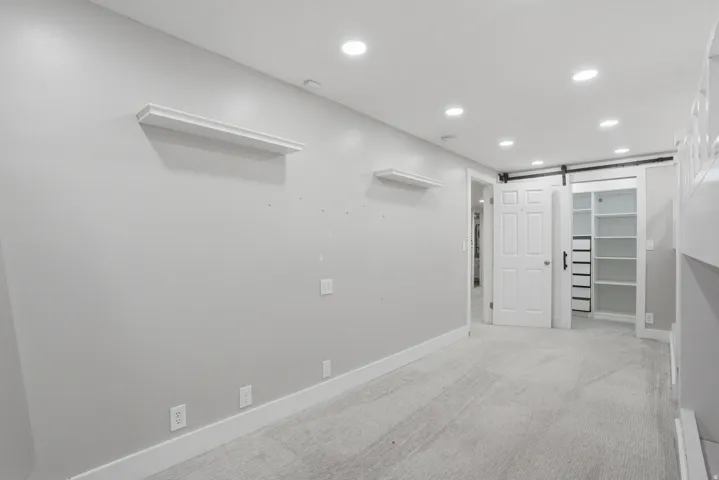 Room with light gray walls, white trim, and light gray carpet