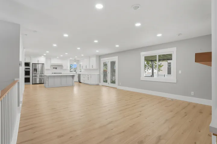 Open-concept living space featuring wood-finish flooring and recessed lighting