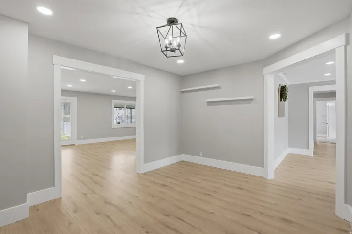 Light wood-finish flooring throughout, complemented by white baseboards and door casings