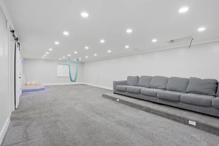 Spacious room featuring light grey carpet flooring throughout