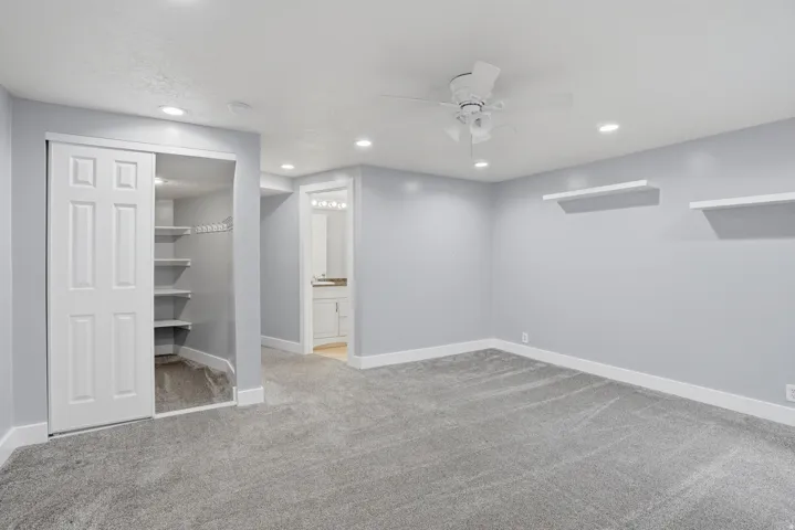 Carpeted room featuring recessed lighting, a ceiling fan, and white baseboards