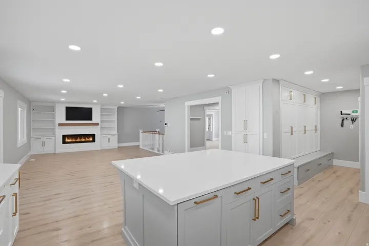 Spacious interior featuring light wood-finish flooring and recessed lighting