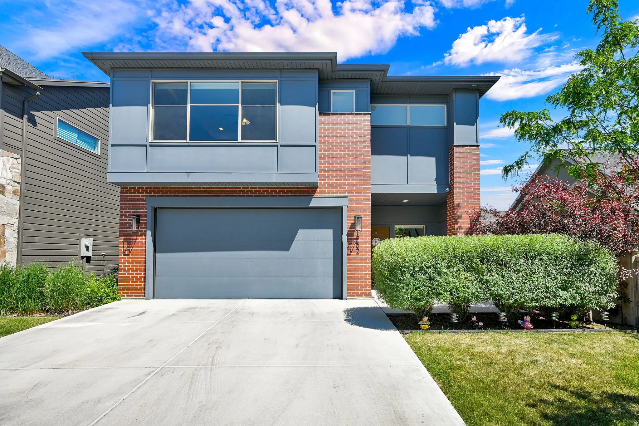 Contemporary exterior featuring brick and paneling accents
