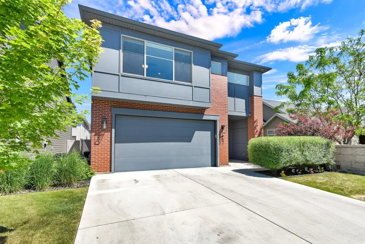 Contemporary facade featuring brick and gray paneling