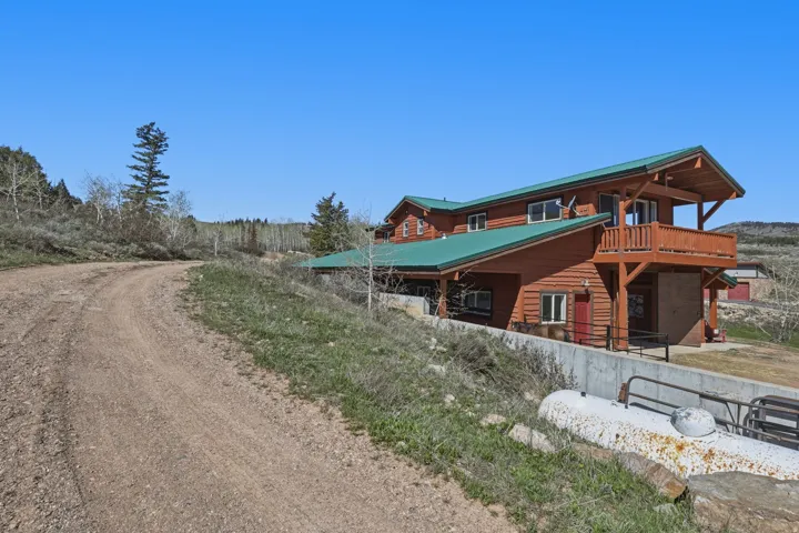 Log-sided residence with green metal roofing