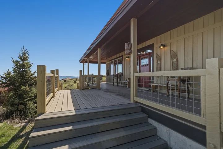 Expansive composite deck with wire railing, offering outdoor living space