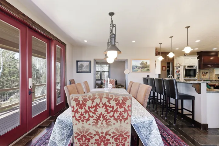 Dining area featuring a contemporary chandelier and rich wood-finish flooring