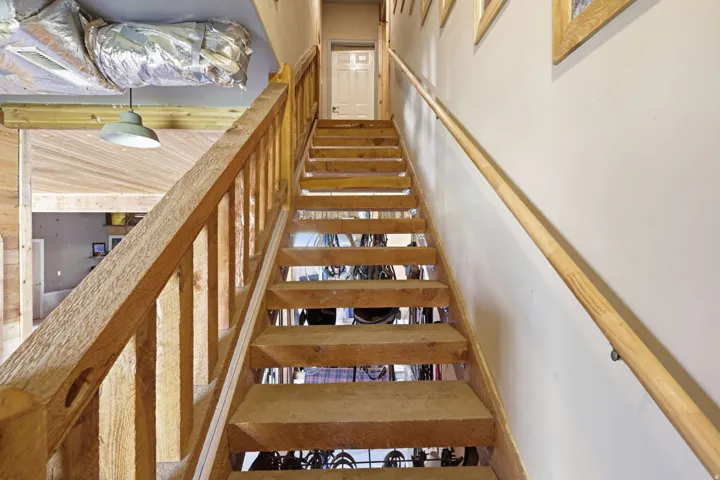Wood-finish staircase with matching banister and handrail