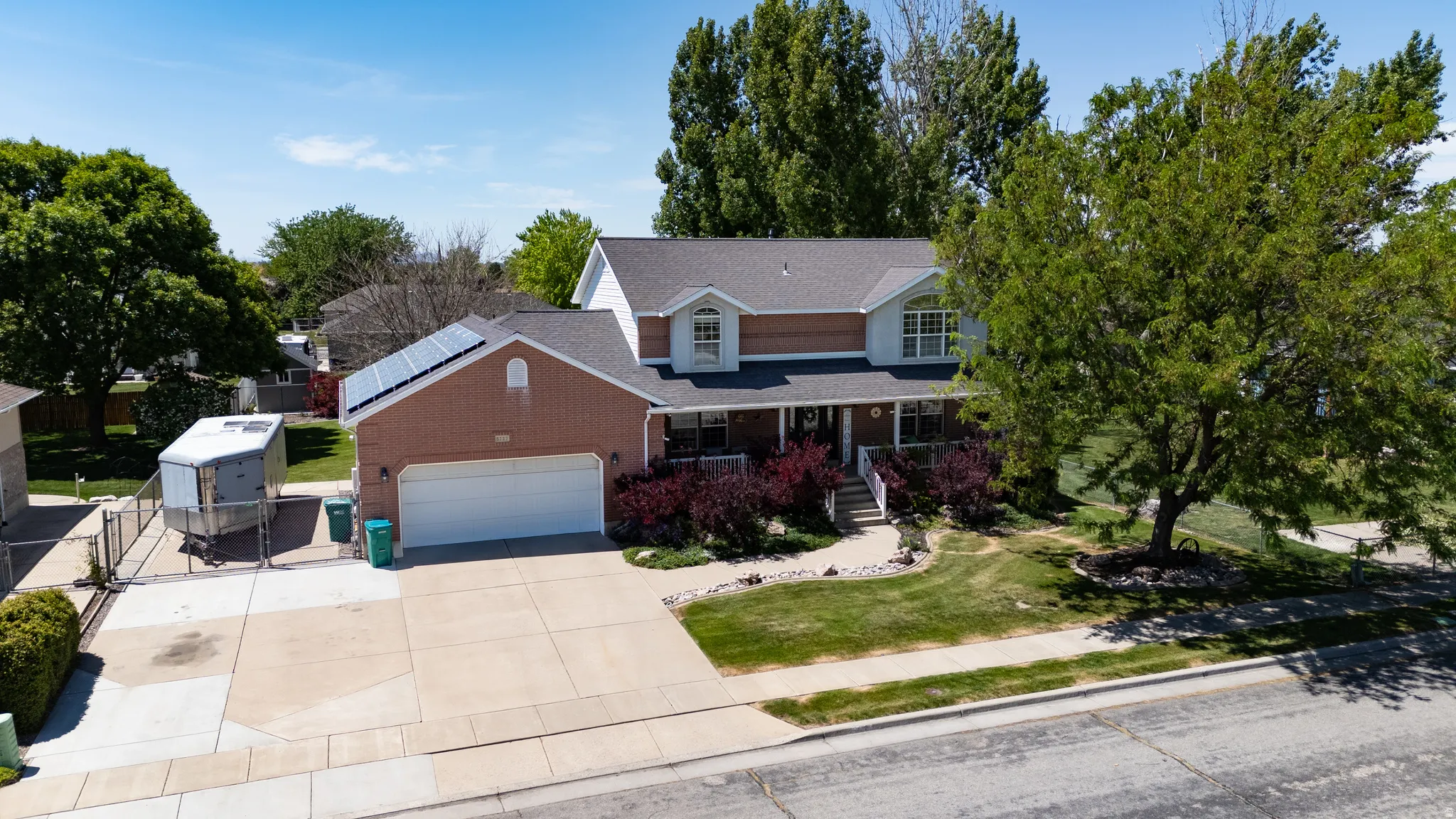 Brick and siding exterior with a covered front porch featuring white railings