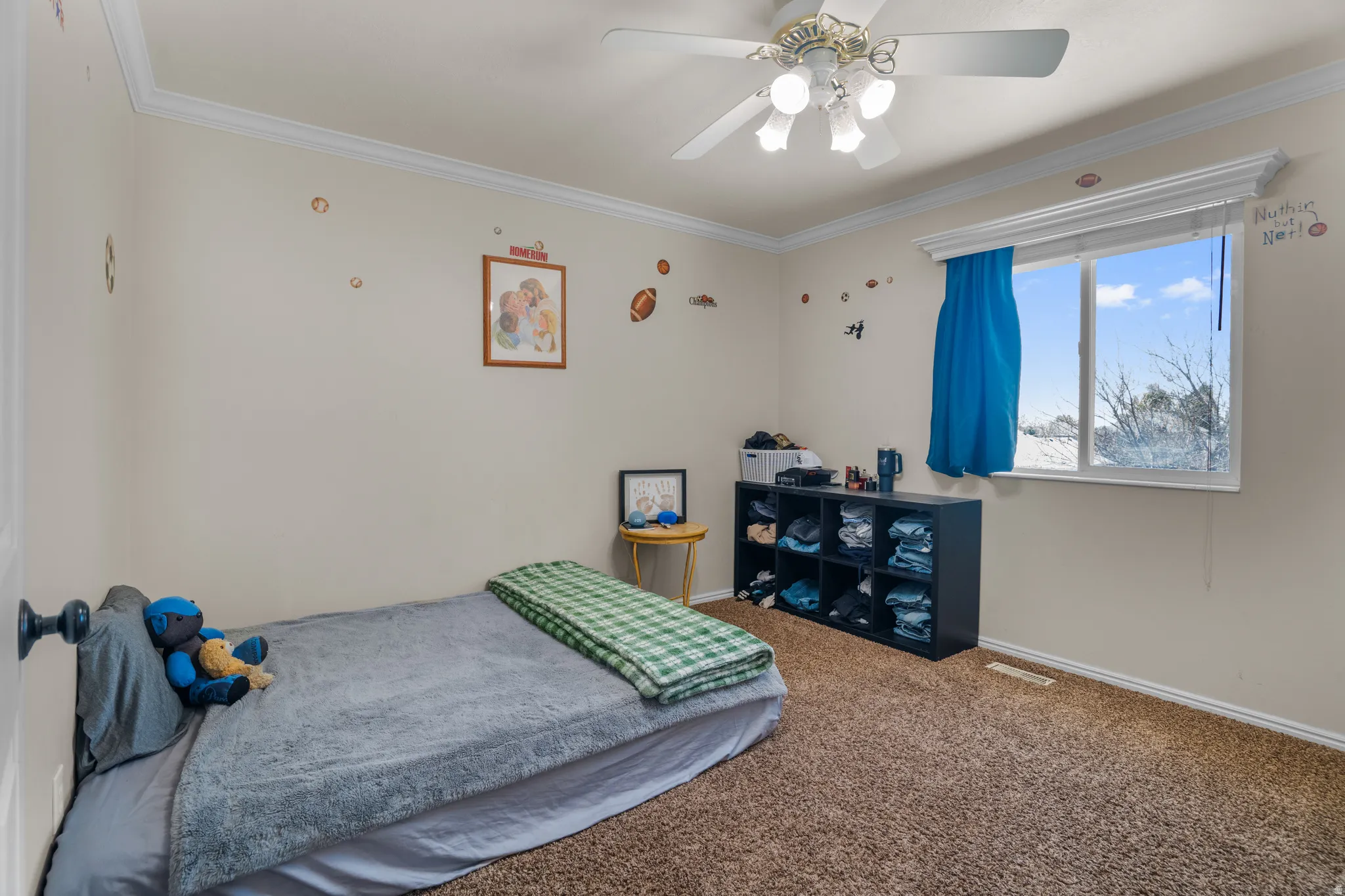 Bedroom with neutral wall paint and brown carpet