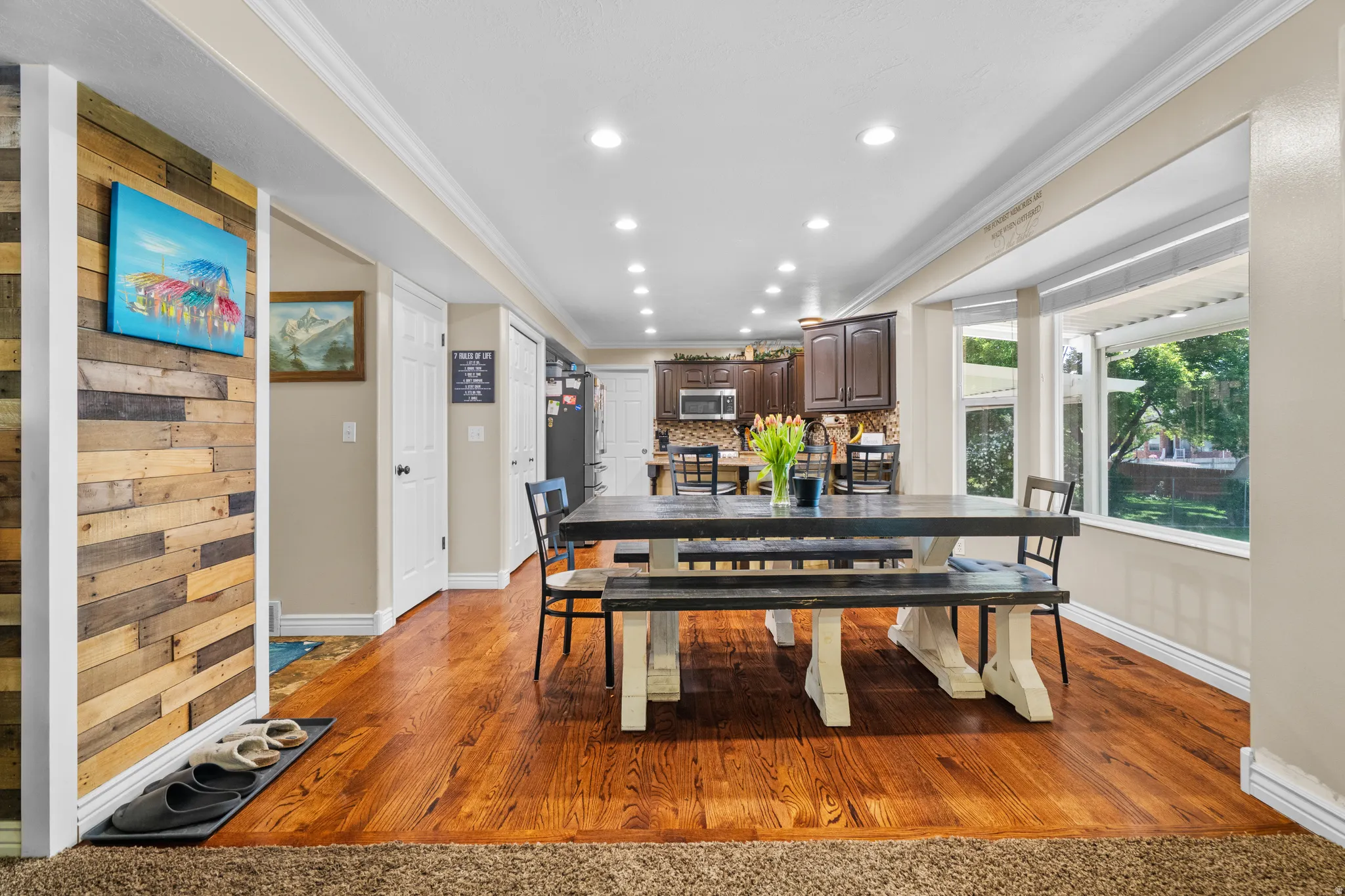 Dining area featuring hardwood flooring, recessed lighting, and a bay window