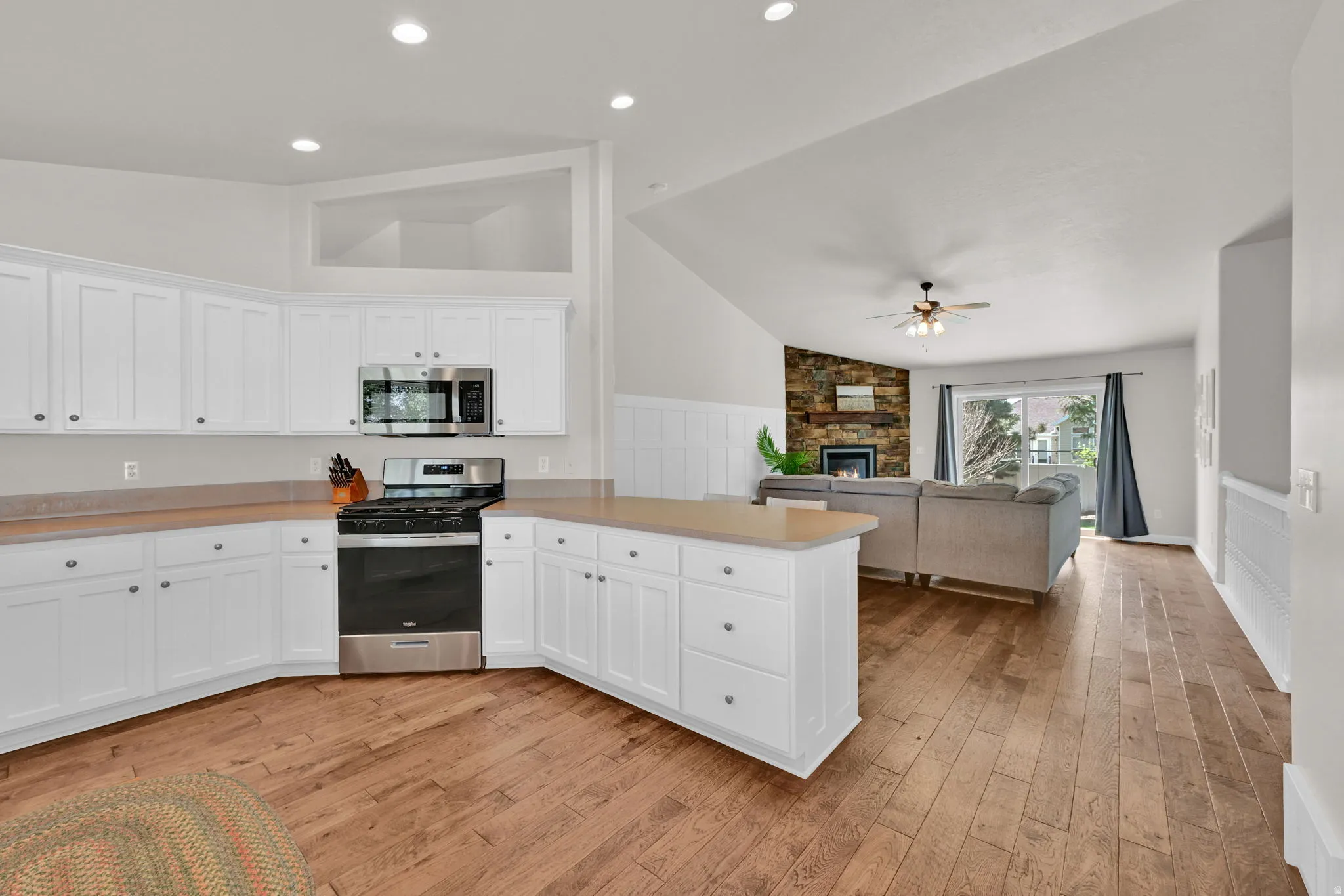 Open-concept kitchen and living area featuring wood-finish flooring