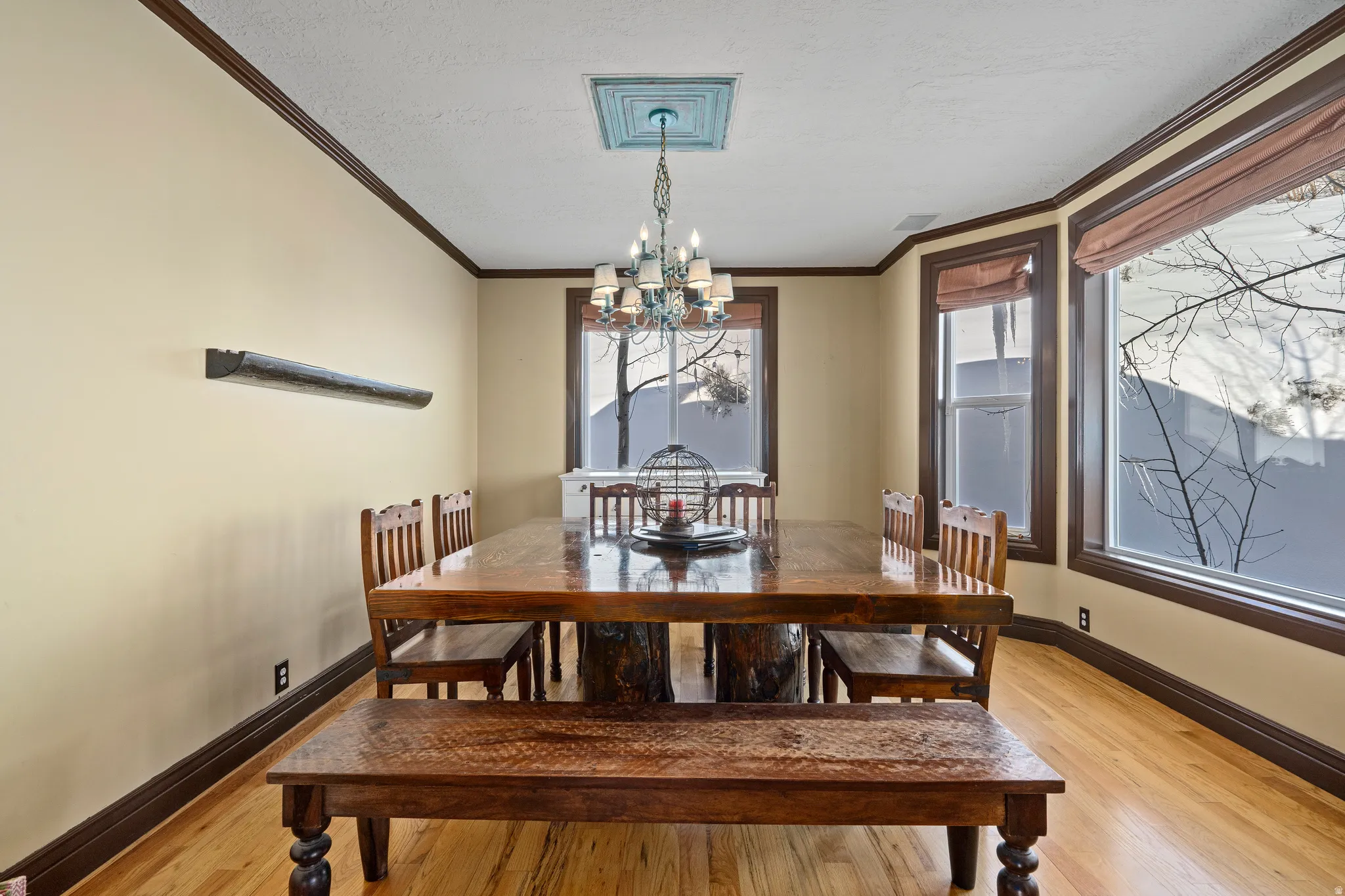 Dining space featuring hardwood flooring and extensive dark wood trim
