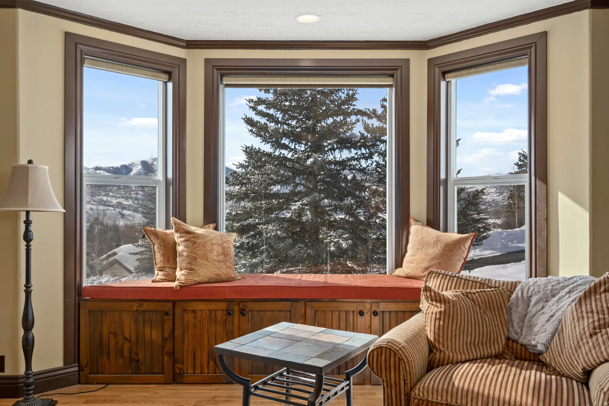 Bay window with a built-in window seat and integrated storage cabinetry