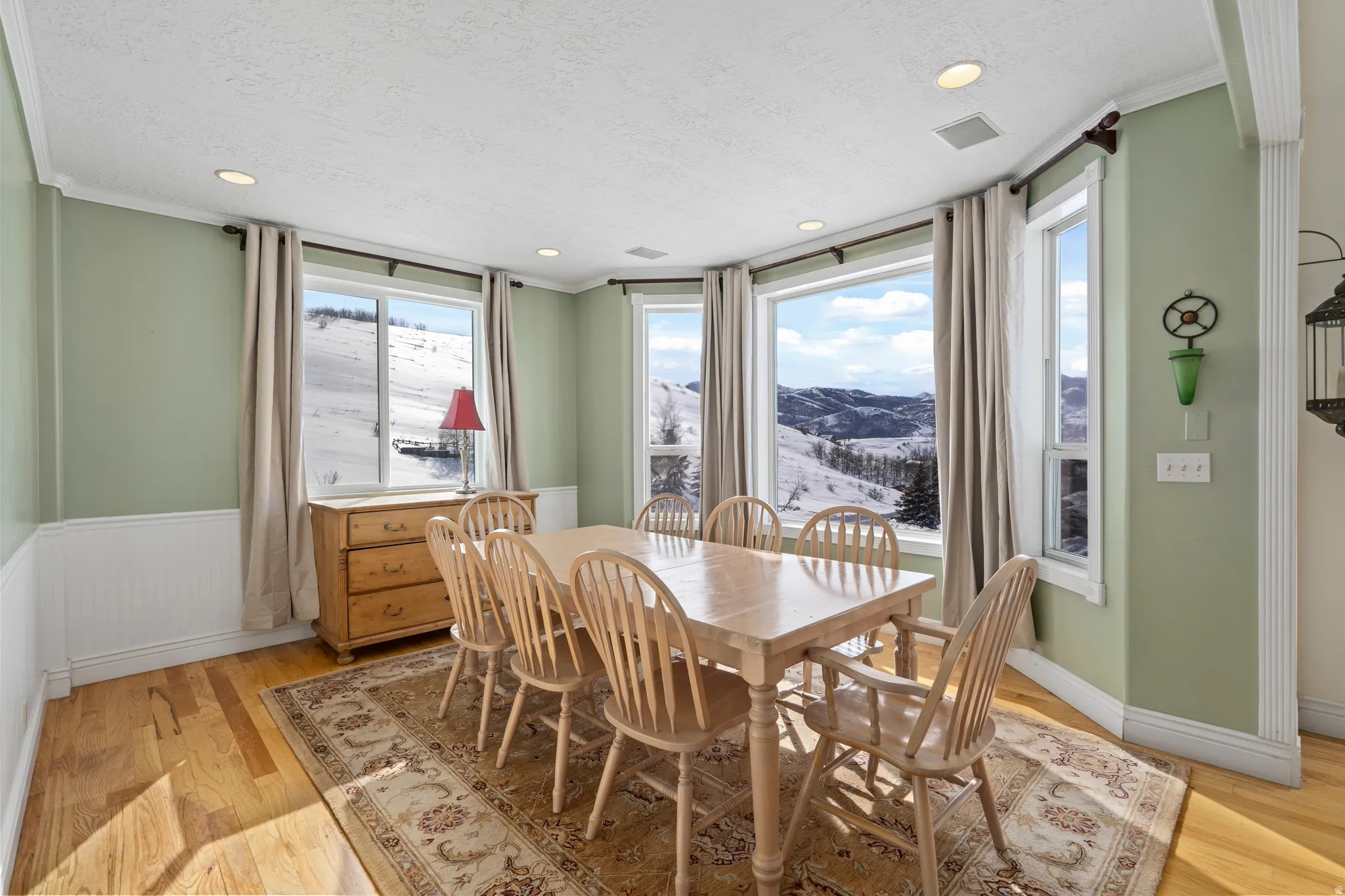 Dining area featuring a bay window with expansive mountain scenery