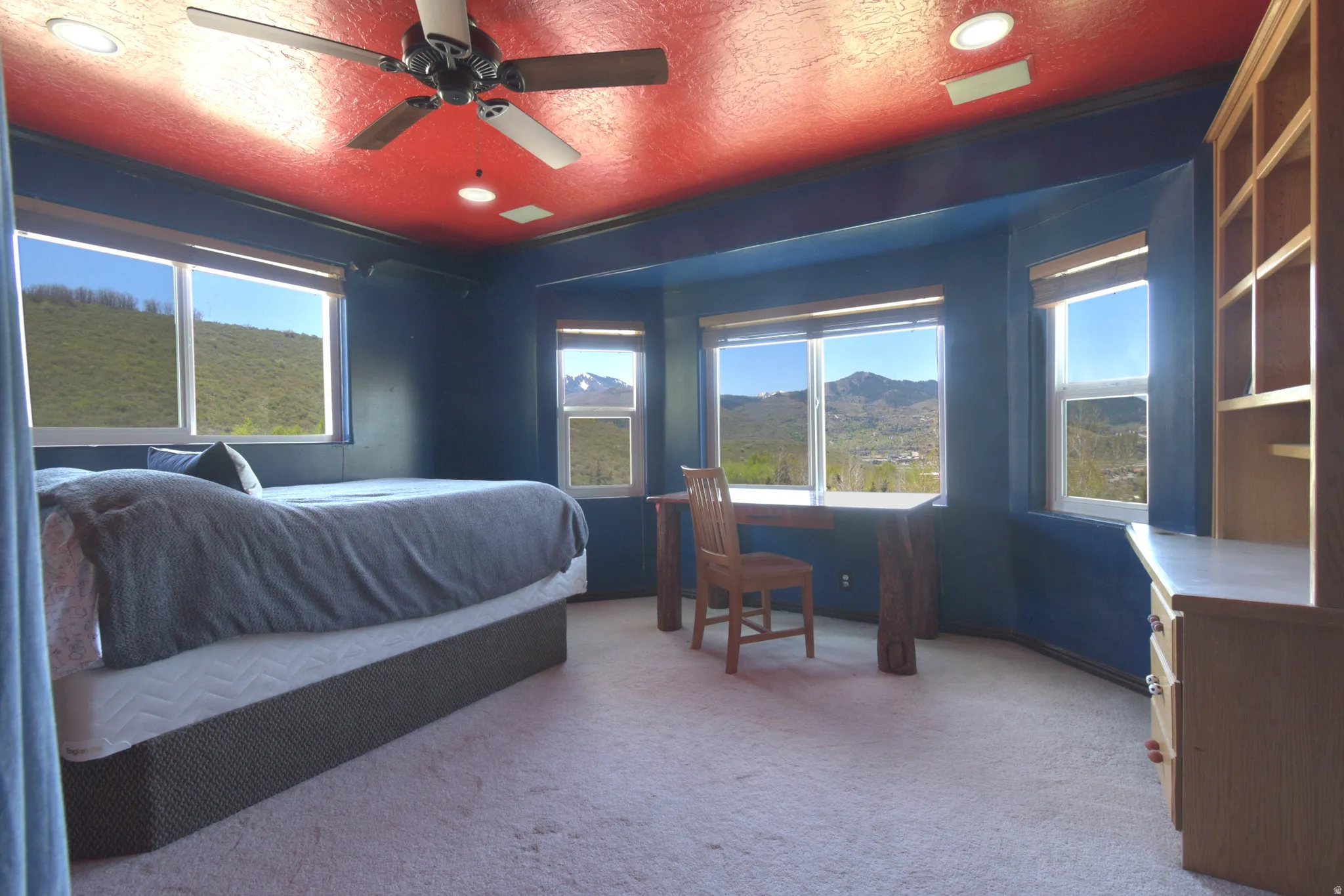 Room featuring multiple windows, a ceiling fan with integrated lighting, and recessed ceiling lights