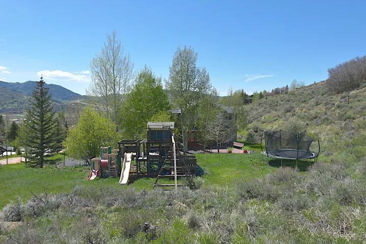 Expansive green lawn with mountain backdrop