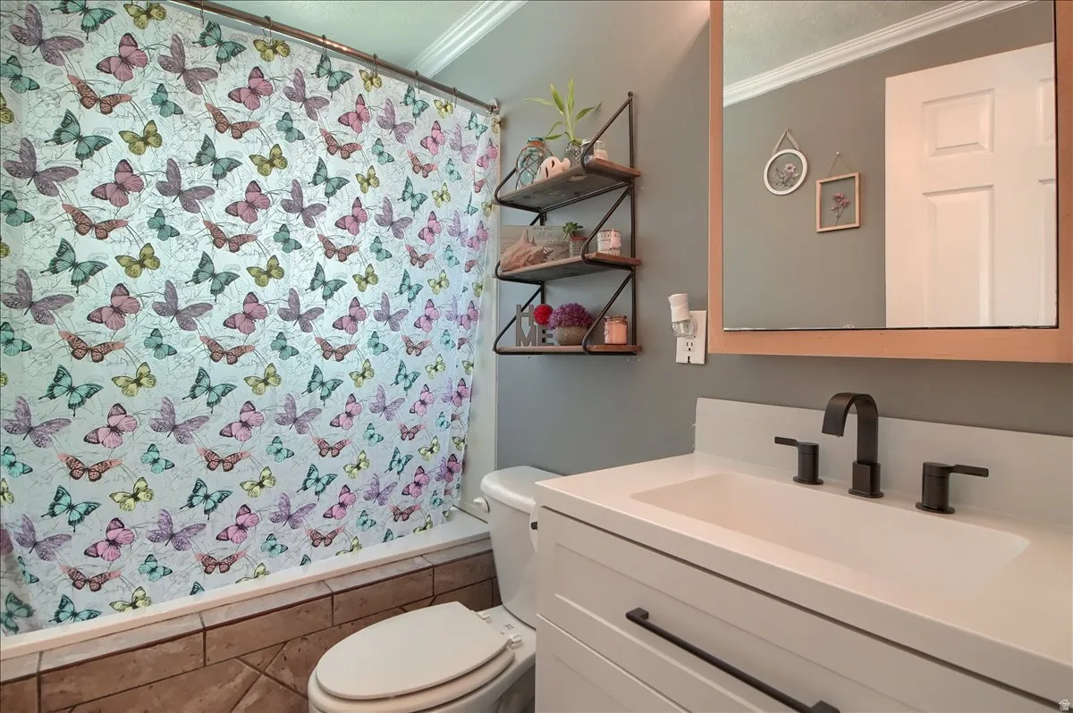 Bathroom featuring a white vanity with a rectangular basin, matte black faucet, and a wood-framed mirror