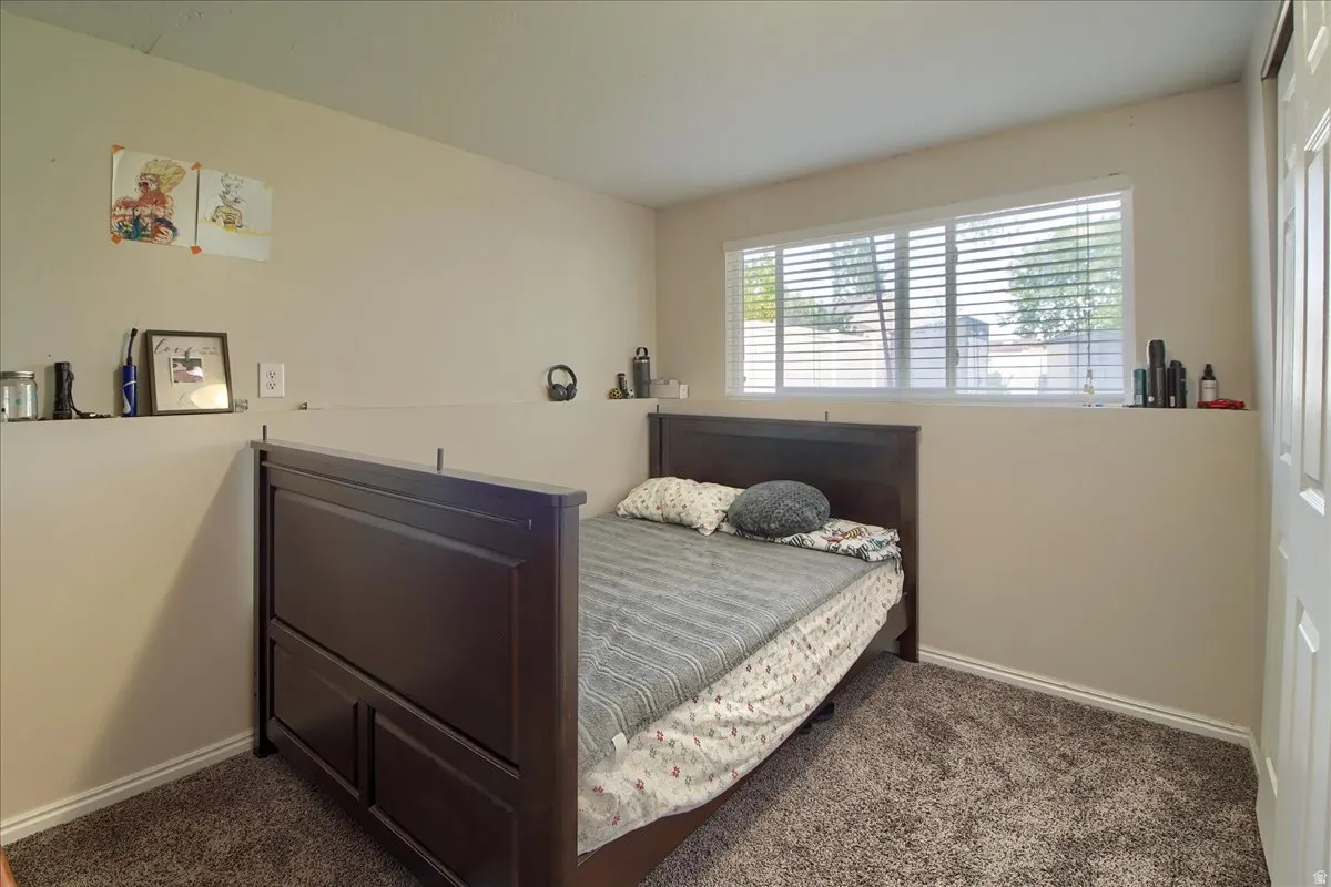 Neutral-toned walls complement the textured brown carpeting