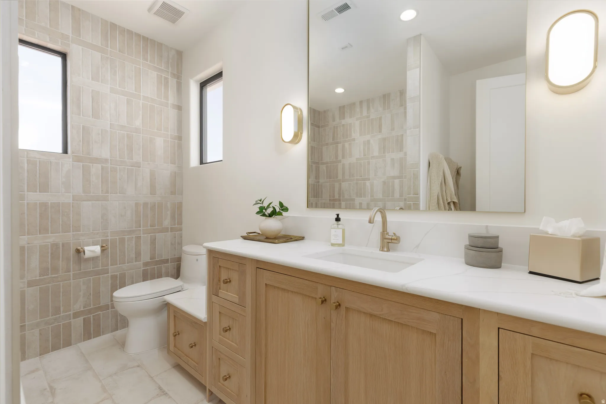 Full bath with vanity and a shower