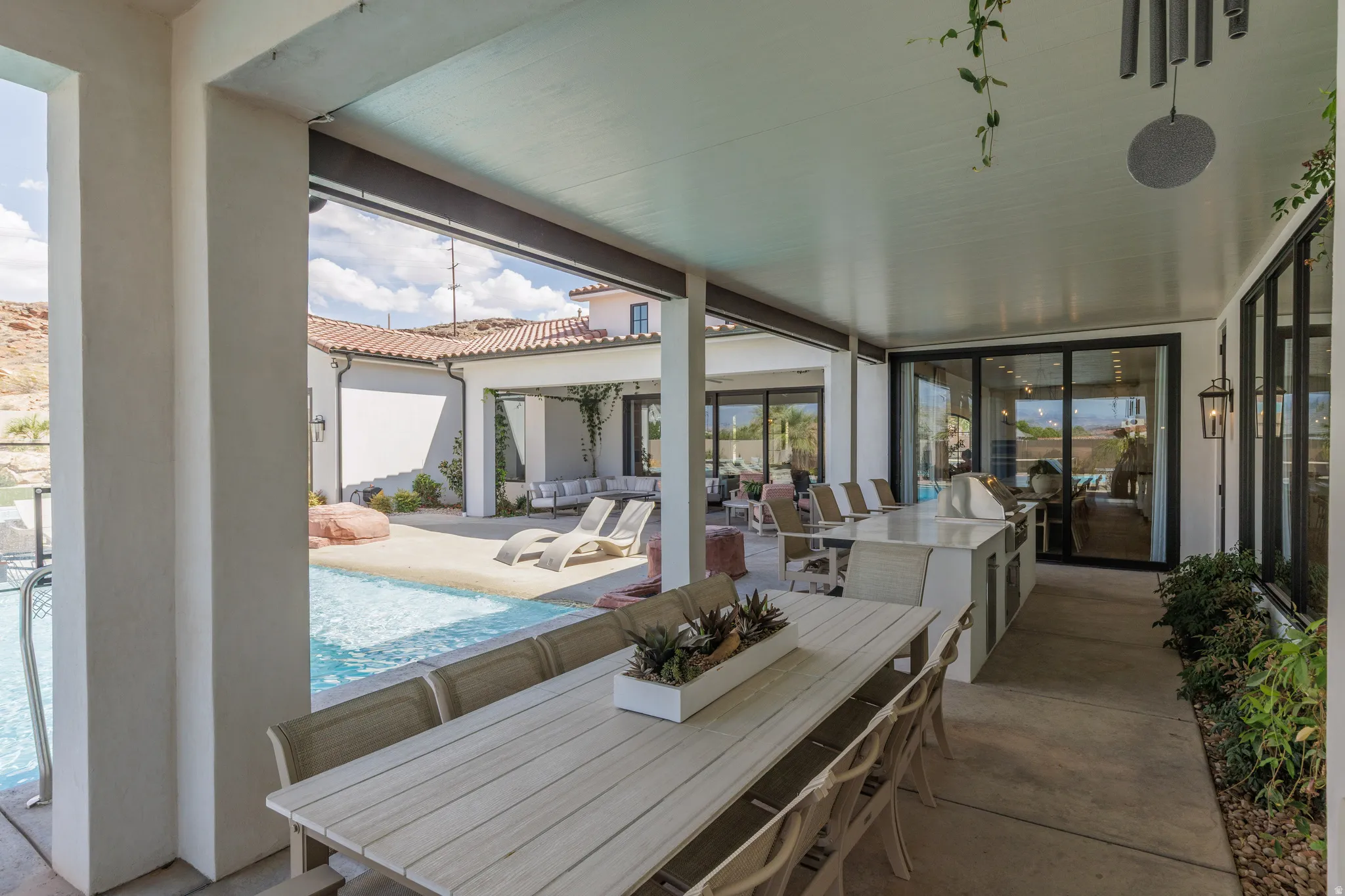 View of patio / terrace with an outdoor living / dining area, an outdoor pool, and a grill